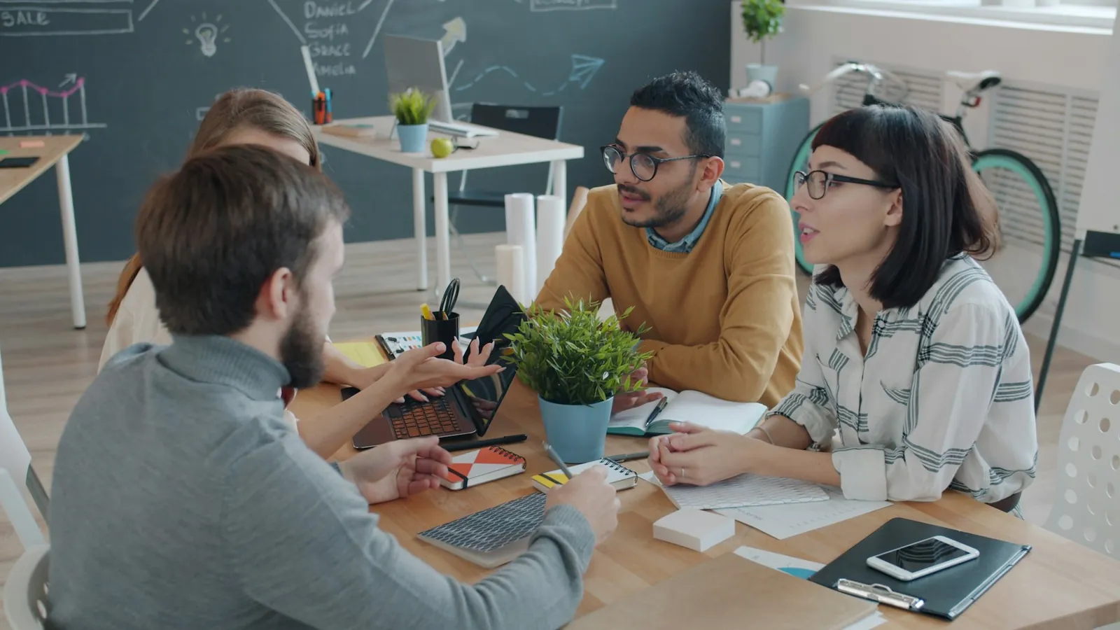 A team collaborating around a table in a bright office
